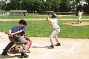 A young baseball player is up to bat.